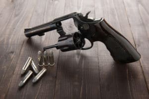 black revolver gun with bullets